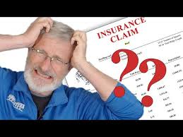 Homeowner looking confused and overwhelmed by insurance claim paperwork - YICN helps navigate this complex process