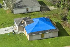 Aerial view of YICN emergency blue tarp installation protecting storm-damaged roof