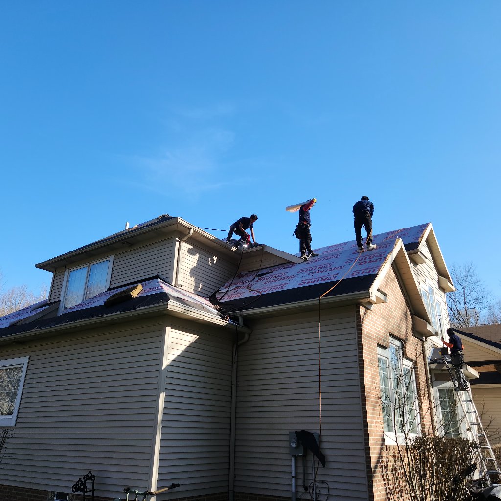 During: YICN crew installing new roofing materials